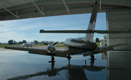 aircraft in Davis Flight Support hangar looking outside at 2Q3
